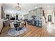 Open living space with hardwood floors, stylish furnishings, and dining area offers great flow for entertaining at 6985 Fallon Cir, Castle Rock, CO 80104