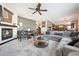 Inviting living room features a fireplace, comfortable seating, and views into the adjacent kitchen and dining areas at 6985 Fallon Cir, Castle Rock, CO 80104