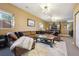 Spacious living room has a brown leather sectional, accent chairs, and recessed lighting at 6985 Fallon Cir, Castle Rock, CO 80104