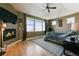 Relaxing main bedroom with a fireplace, tray ceiling, ceiling fan, and mountain views at 6985 Fallon Cir, Castle Rock, CO 80104