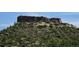 Picturesque landscape featuring a prominent rocky outcrop, lush greenery, and open skies, capturing the natural beauty of the terrain at 6985 Fallon Cir, Castle Rock, CO 80104
