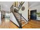 Open staircase with dark wood banister and light wood stairs leading to the second story at 6985 Fallon Cir, Castle Rock, CO 80104