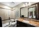 Bathroom featuring a glass enclosed shower, granite vanity, and decorative mosaic tile at 10243 Spring Green Dr, Englewood, CO 80112