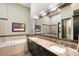 Bathroom featuring double sinks, granite countertops, a soaking tub, and glass enclosed shower at 10243 Spring Green Dr, Englewood, CO 80112