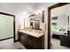 Bright bathroom featuring granite vanity with double sinks, and an adjacent bedroom view at 10243 Spring Green Dr, Englewood, CO 80112