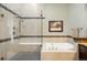 Elegant bathroom featuring a soaking tub, glass enclosed shower, and modern fixtures at 10243 Spring Green Dr, Englewood, CO 80112