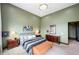 Spacious bedroom with an elegant light fixture and neutral carpet at 10243 Spring Green Dr, Englewood, CO 80112