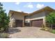 Elegant home exterior featuring a brick driveway and two-car garage at 10243 Spring Green Dr, Englewood, CO 80112