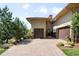 Home featuring a large driveway with two-car garage and stone accents at 10243 Spring Green Dr, Englewood, CO 80112