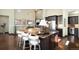 Large kitchen island with seating, dark cabinets, stainless appliances, and granite countertops at 10243 Spring Green Dr, Englewood, CO 80112