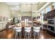 Kitchen with marble island, seating, stainless appliances, and dark cabinets at 10243 Spring Green Dr, Englewood, CO 80112