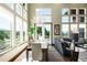 Living room with dining table, a large chandelier, and large windows providing natural light at 10243 Spring Green Dr, Englewood, CO 80112