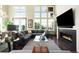 Spacious living room with fireplace, large windows, and hardwood floors at 10243 Spring Green Dr, Englewood, CO 80112