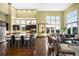 Open-concept layout featuring a kitchen island, dining area, and living space with large windows at 10243 Spring Green Dr, Englewood, CO 80112