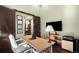 Bright office space featuring hardwood floors, modern desk, TV, and neutral paint at 10243 Spring Green Dr, Englewood, CO 80112