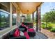 Cozy covered patio with comfortable seating, a hot tub, and views of the landscaped backyard at 10243 Spring Green Dr, Englewood, CO 80112