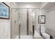 Clean and modern tiled shower with built-in bench and glass door at 10243 Spring Green Dr, Englewood, CO 80112