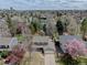 An aerial view of a home with mature landscaping, a driveway, a fenced backyard, and a well-maintained front yard at 6719 E Costilla Cir, Centennial, CO 80112