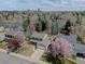 Aerial view of a home with lush greenery, trees, and a cityscape in the distance at 6719 E Costilla Cir, Centennial, CO 80112