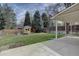 View of fenced backyard with lawn, storage shed, and patio at 6719 E Costilla Cir, Centennial, CO 80112