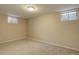 View of basement featuring two windows and neutral-colored walls and flooring at 6719 E Costilla Cir, Centennial, CO 80112