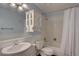 A full bath features blue accents, a tub/shower combo, and a vanity with a white sink at 6719 E Costilla Cir, Centennial, CO 80112