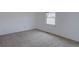 Empty carpeted bedroom with light walls and a bright window at 6719 E Costilla Cir, Centennial, CO 80112