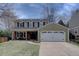 Inviting two-story home featuring a well-maintained lawn, attached garage and dormer windows at 6719 E Costilla Cir, Centennial, CO 80112