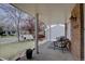 View of covered front porch featuring brick facade and patio seating area at 6719 E Costilla Cir, Centennial, CO 80112