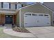 Close up of attached garage with white door and decorative black handles and hinges at 6719 E Costilla Cir, Centennial, CO 80112