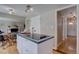 Kitchen island boasts a built in cooktop with the dining and living room easily accessible at 6719 E Costilla Cir, Centennial, CO 80112
