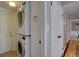 Convenient laundry area features stacked washer and dryer units near access to hall and rear entry at 6719 E Costilla Cir, Centennial, CO 80112