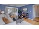 Living room featuring hardwood flooring and blue walls, open concept to dining room at 6719 E Costilla Cir, Centennial, CO 80112