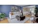 Living room with blue walls, hardwood flooring and view into dining room at 6719 E Costilla Cir, Centennial, CO 80112