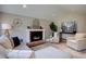 Comfortable living room area with brick fireplace, neutral paint, and lots of natural light at 6719 E Costilla Cir, Centennial, CO 80112
