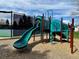 This is a view of a colorful playground in a park area surrounded by wood chips and a secure fence at 6719 E Costilla Cir, Centennial, CO 80112