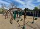 A view of outdoor playground equipment with a climbing structure and monkey bars on a wood chip surface at 6719 E Costilla Cir, Centennial, CO 80112