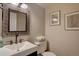 Tastefully updated powder room includes a square sink, modern faucet, and stylish framed mirror at 6719 E Costilla Cir, Centennial, CO 80112