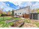 Expansive backyard boasts a patio, garden beds, and a shed, creating a versatile outdoor space at 4808 S Ward Way, Morrison, CO 80465
