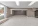 Finished basement featuring carpeted floors, sliding glass doors to a patio and fluorescent lighting at 4808 S Ward Way, Morrison, CO 80465