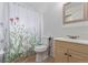 This bathroom features a shower with floral curtain and a wood vanity with sink at 4808 S Ward Way, Morrison, CO 80465