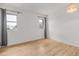 Bedroom featuring light hardwood floors and two large windows letting in plenty of natural light at 4808 S Ward Way, Morrison, CO 80465