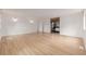 Bright bedroom featuring wood-look floors, white walls, and modern lighting fixtures at 4808 S Ward Way, Morrison, CO 80465