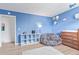 This bedroom features a bean bag and white shelving unit with blue walls at 4808 S Ward Way, Morrison, CO 80465