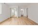 Spacious bedroom featuring wood-look floors, closet with mirror doors and modern ensuite bathroom at 4808 S Ward Way, Morrison, CO 80465