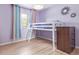 Cozy bedroom with a loft bed, laminate flooring, and a bright, playful atmosphere at 4808 S Ward Way, Morrison, CO 80465