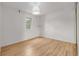 Bedroom featuring light hardwood floors and a window letting in plenty of natural light at 4808 S Ward Way, Morrison, CO 80465