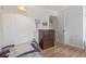 Bedroom with wood floors features a dresser and closet access at 4808 S Ward Way, Morrison, CO 80465