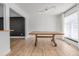 Minimalist dining area with light wood floors, white walls, and a large wooden table at 4808 S Ward Way, Morrison, CO 80465