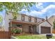 Lovely two-story home with a charming front porch and well-manicured lawn, plus a two-car garage at 4808 S Ward Way, Morrison, CO 80465